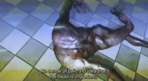 Detailed view of the AI-generated figure’s back and limbs contorting unnaturally. Subtitle reads: “No sense of pain, no idea that the head is important.”
